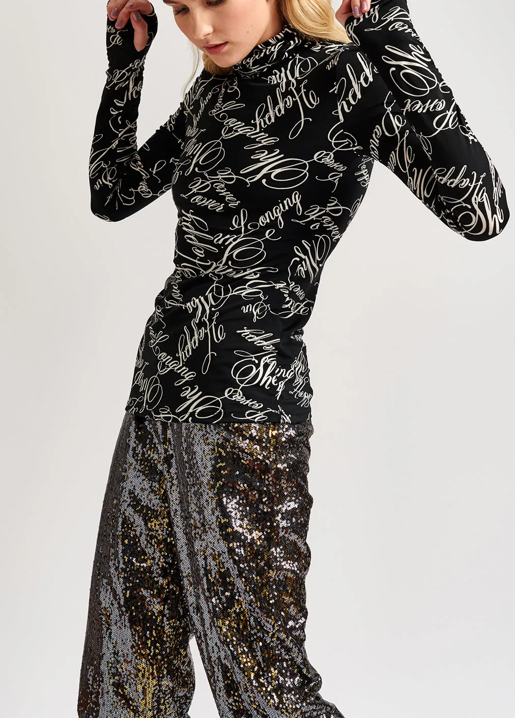 Black turtleneck top with script-print